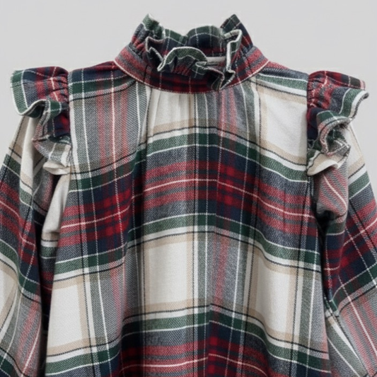 Plaid dress with ruffled shoulders on a light gray background