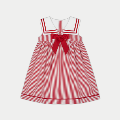 Red and white striped dress with a large bow on a light gray background