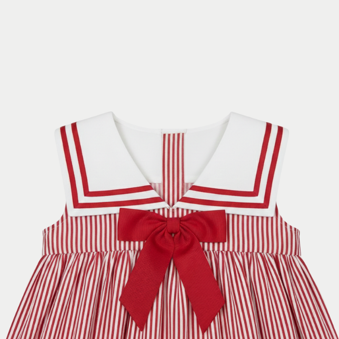 Red and white striped dress with a large bow on a light gray background