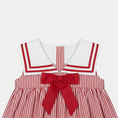 Red and white striped dress with a large bow on a light gray background