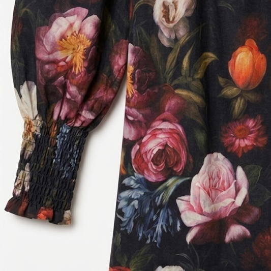 Dark Floral patterned garment with long sleeves on a white background