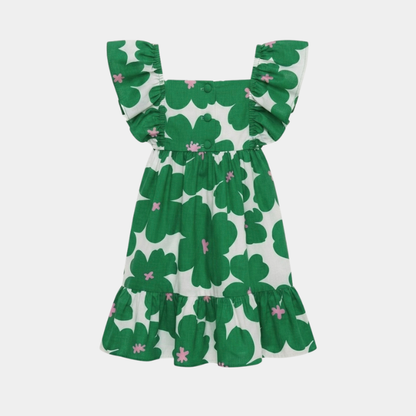 A green and white clover patterned dress with ruffled shoulder straps and a tiered skirt, shown against a light gray background.