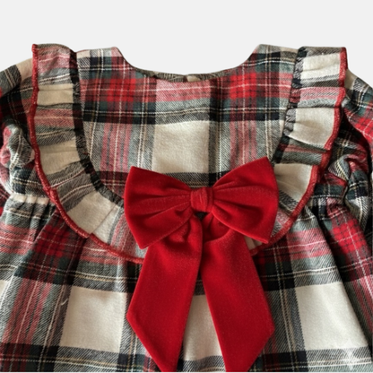 Plaid garment with a large red bow on a white background