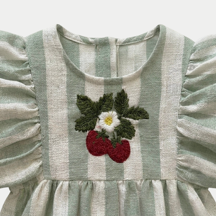 Striped sage romper with puff sleeves and strawberry embroidery design on a light gray background