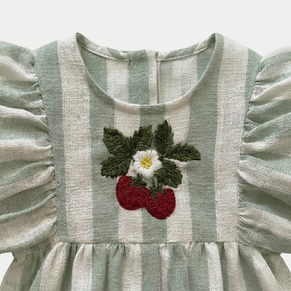 Striped sage romper with puff sleeves and strawberry embroidery design on a light gray background