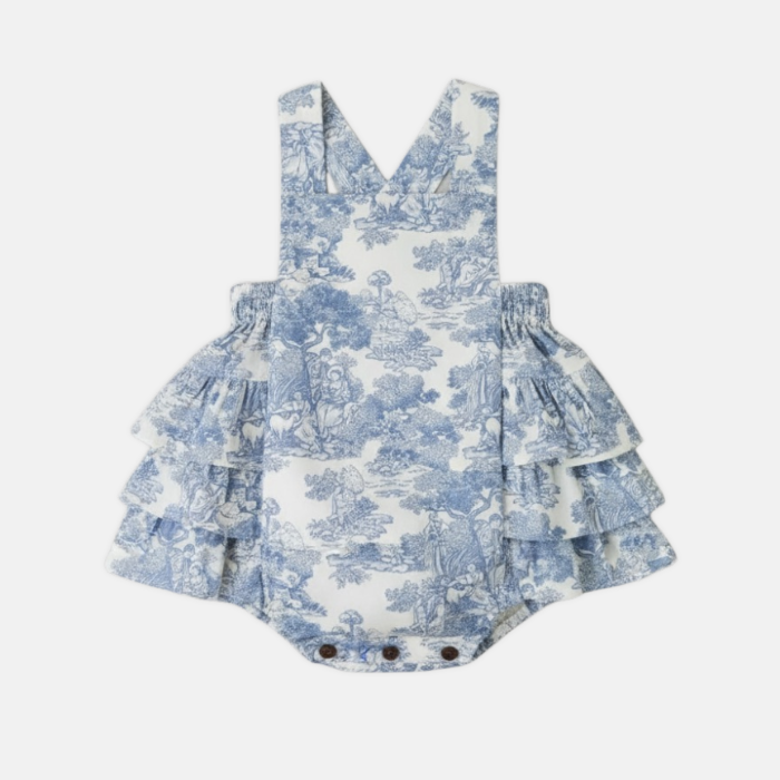 Blue and white toile romper on a white background