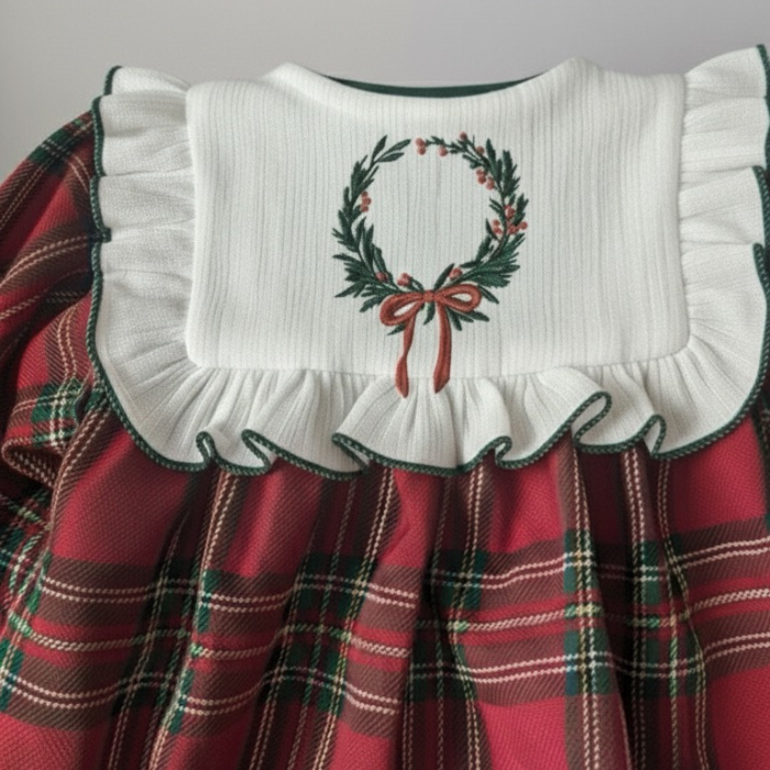 Red plaid dress with embroidered yoke featuring a Christmas wreath design.