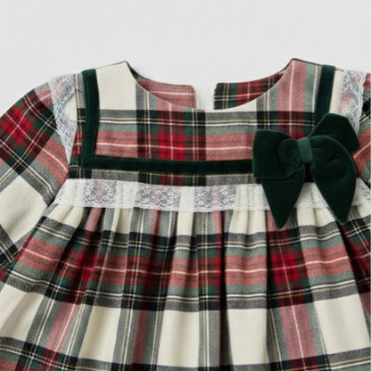 Plaid dress with a large green bow on a white background