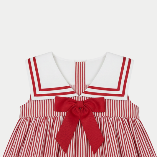 Red and white striped dress with a large bow on a light gray background