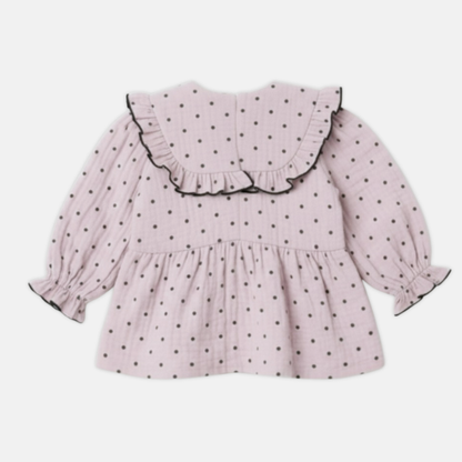 Pink polka dot dress with ruffled collar on a white background