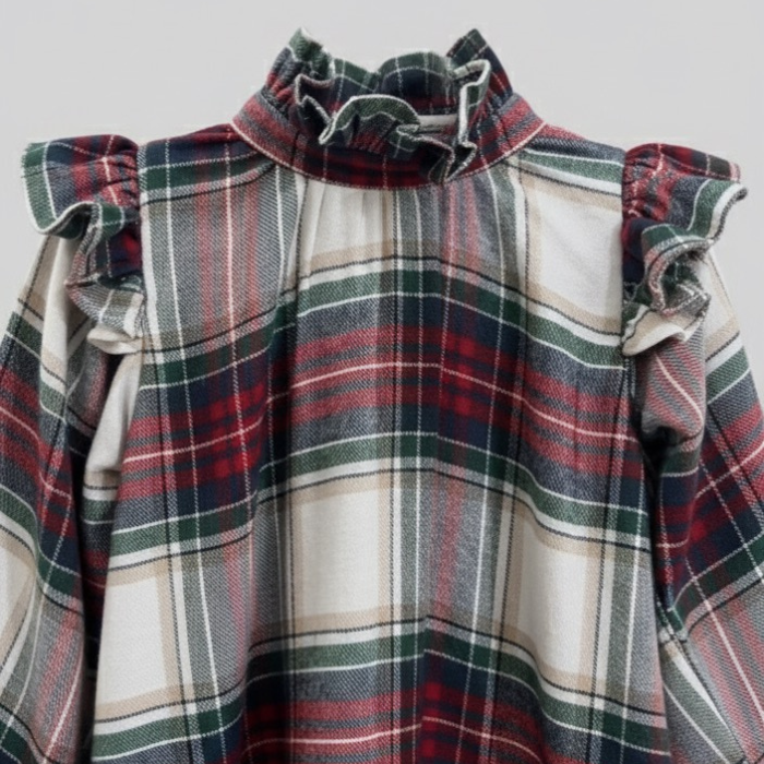Plaid dress with ruffled shoulders on a light gray background