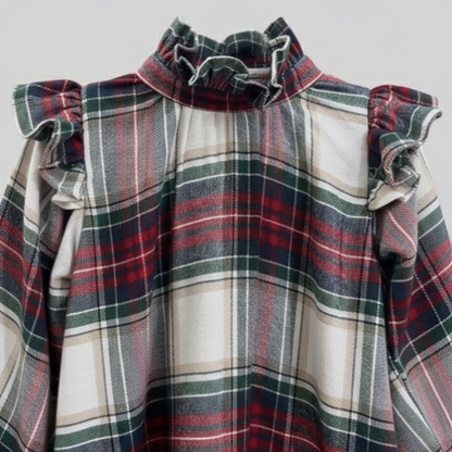 Plaid dress with ruffled shoulders on a light gray background