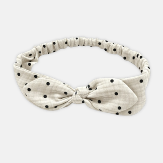 Offwhite muslin headband with black polka dots on a white background